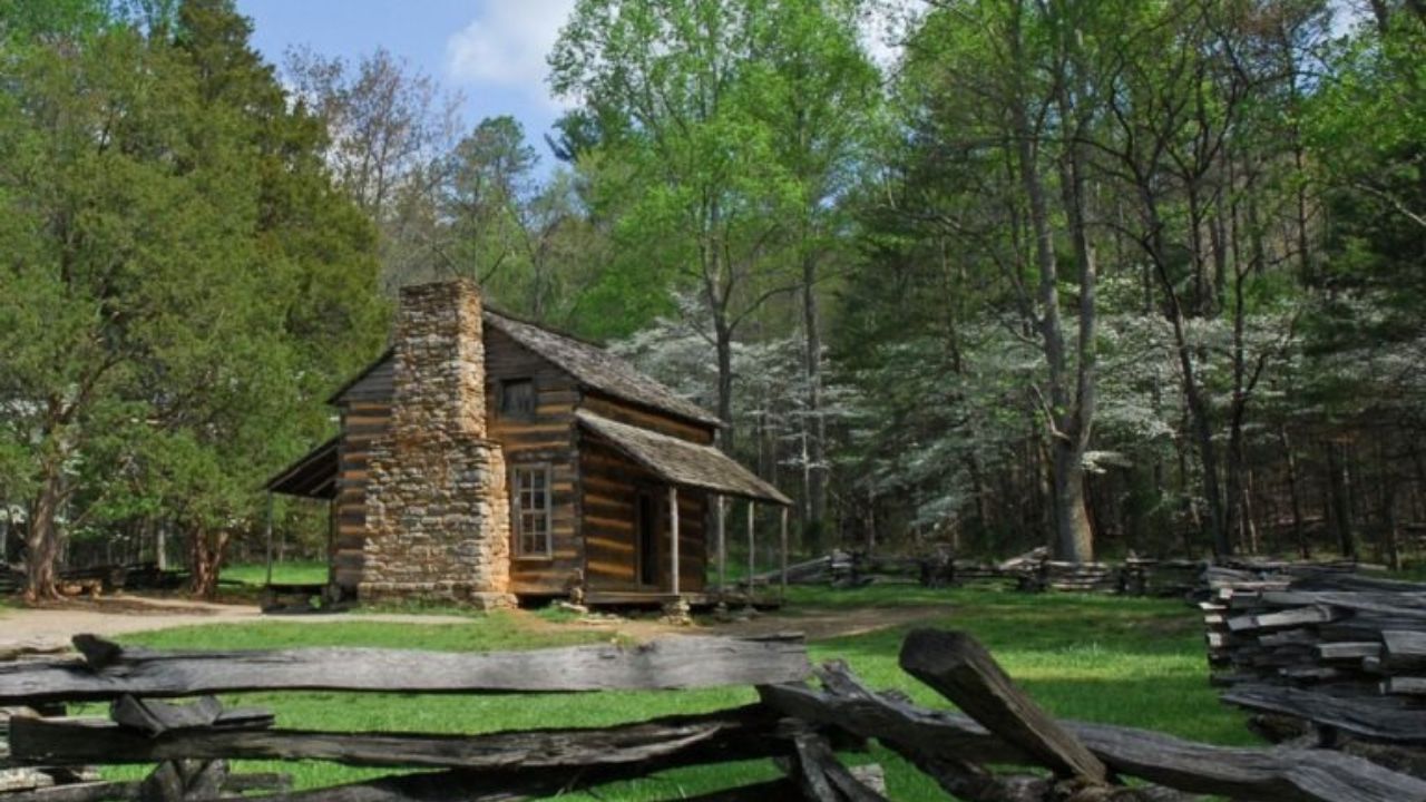 A rustic log cabin surrounded by trees in Cades Cove.